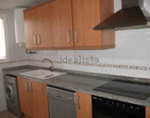 a kitchen with a sink and a stove at Precioso apartamento 1ª linea playa con piscina in Vinaròs +15 photos