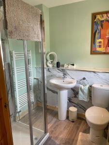 a bathroom with a shower and a sink and a toilet at Snowberry Cottages No1 in Onich