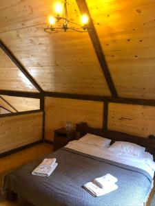 1 dormitorio con 1 cama en una cabaña de madera en Шале "Конопка" en Bukovel