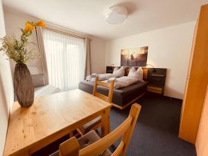 a living room with a couch and a table at Haus Heimat Wagrain in Wagrain