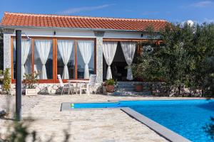 a house with a swimming pool in front of it at 4 Fortresses in Šibenik