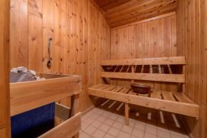 a wooden bathroom with a tub and a sink at Luccombe Farm Holiday Cottages in Milton Abbas