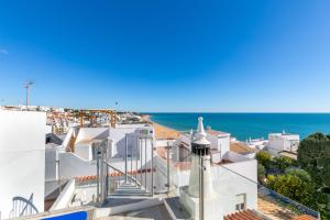 a view of the ocean from the roof of a white building at Typical Fisherman's Cottage with amazing sea views! in Albufeira