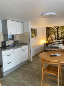 a kitchen and dining room with a table and a table and chairs at HeiSa in Bitzen