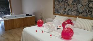 a room with a bed with red and white decorations at Casa Chelo Alojamientos Turisticos in Mazaricos