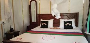 a bedroom with a bed with flowers on it at Sigiri Panaromic Tree House in Sigiriya
