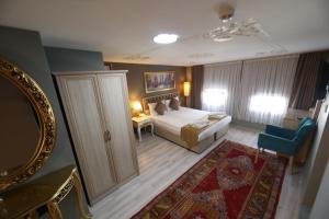 a bedroom with a bed and a room with a mirror at Sultans Royal Hotel in Istanbul