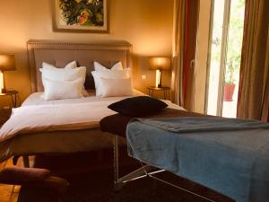 a bedroom with a large bed with white pillows at Bastide Sainte Trinide in Sanary-sur-Mer