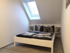 a bed in a room with a skylight at Hotel Villa Alice in Thale