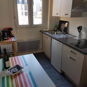 a small kitchen with a sink and a counter at Granville Plage Plat Gousset in Granville