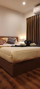 a large bed in a room with a bedskirts at Lahabana Huahin by Moji in Hua Hin