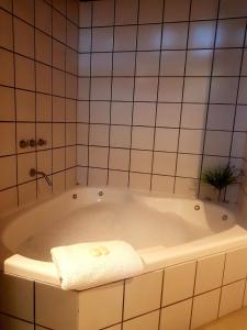 a bathroom with a tub with a towel on it at Medanos in Las Gaviotas