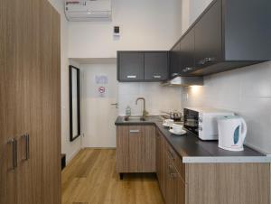 a kitchen with a sink and a counter top at RES City Residence Hotel Budapest in Budapest