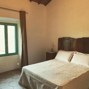a bedroom with a bed and a window at Corte Boero Bed&Breakfast in Capoterra