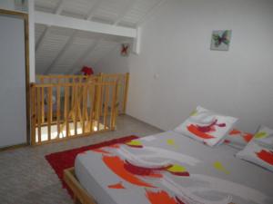 una camera con letto e culla di IMMEUBLE NEBOT a Grand-Bourg