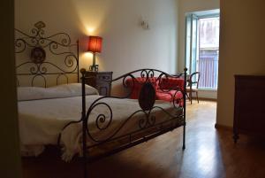 a bedroom with a bed with a wrought iron frame at Appartamento Vannucci 10 in Perugia