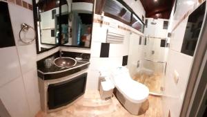 a small bathroom with a toilet and a sink at Coyaba Tropical Elegant Adult Guesthouse in Manuel Antonio +117 photos