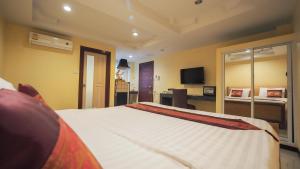 Ένα ή περισσότερα κρεβάτια σε δωμάτιο στο Joy House Jomtien Beach