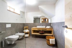 a bathroom with a toilet and a sink and a mirror at Daimlhof Ferienwohnung Schlernstein in Völs am Schlern