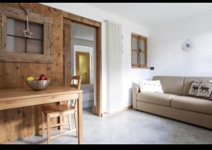 a living room with a couch and a table at CASA CARCENTINA in Bormio