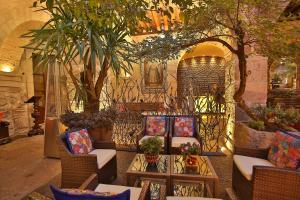 a lobby with chairs and a table and trees at Hotel De La Soledad in Morelia