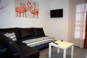 a living room with a couch and a table at Holiday aptm - MorningSun2 - Sithonia in Ayios Nikolaos Sithonia