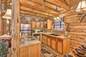 a kitchen with wooden cabinets and a stove top oven at Rustic Breckenridge Cabin with Private Hot Tub in Breckenridge