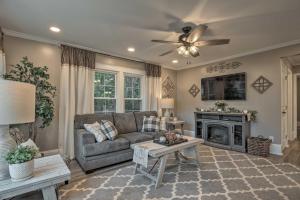 a living room with a couch and a fireplace at Peaceful Renovated Home with Deck on Half Acre! in Asheboro
