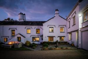 a large white house with lights on at Grade 2 Listed 2 bedroom Pet Friendly - Parking - Hot Tub - very quiet in Bowness-on-Windermere