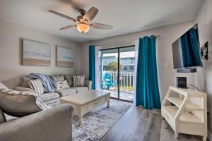 a living room with a couch and a table at Orange Beach Condo Private Boat Dock and Ramp in Orange Beach