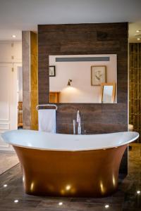 a bath tub in a bathroom with a sink at Grade 2 Listed 2 bedroom Pet Friendly - Parking - Hot Tub - very quiet in Bowness-on-Windermere