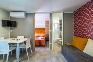 a living room with a table and a couch at Villaggio Camping Odissea in Marina di Camerota