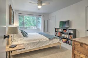 a bedroom with a bed and a window and a tv at Cozy Retreat with Deck about 2 Mi to Pinecrest Lake! in Strawberry