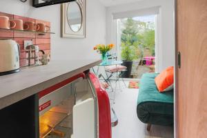 a kitchen with a red appliance in a room at Plush city Centre Micropad with Parking in Brighton & Hove