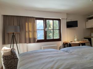 a hotel room with two beds and a window at Davosblick in Davos