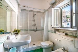 a bathroom with a sink and a toilet and a shower at Amalfi Centre Flats in Amalfi +103 photos