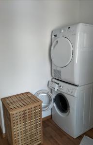 a washer and dryer with a washing machine in a room at Davosblick in Davos