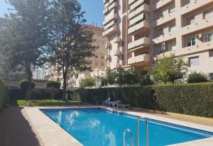 a swimming pool in front of a building at Apartamento Terrazas de la Veguilla in Fuengirola