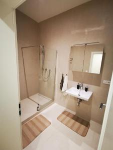 a bathroom with a shower and a sink at Atlas Apartment in the historical center of Košice with free private parking in Košice