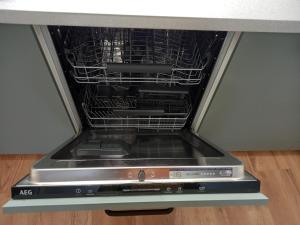 an oven with its door open in a kitchen at Atlas Apartment in the historical center of Košice with free private parking in Košice