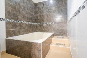 a bathroom with a white tub and a shower at Ayenda La Tua Casa in Bogotá +16 photos