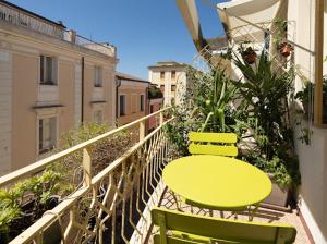 a balcony with a table and two chairs on a balcony at Sul Corso Affittacamere in Nuoro