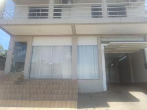 a large white building with stairs and windows at Pousada Ágata in Ametista do Sul