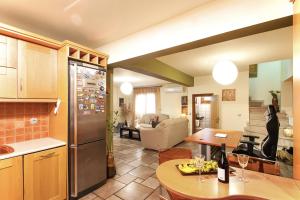 a kitchen and living room with a stainless steel refrigerator at Kaiti`s House in Skiathos