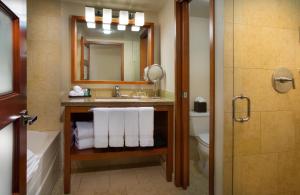 a bathroom with a sink and a toilet and a mirror at The Paramount Hotel in Seattle +29 photos