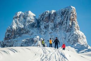 a group of people standing on a snow covered mountain at Hotel Corona in Cortina dʼAmpezzo