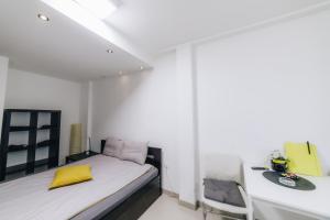 a small bedroom with a bed and a desk at Apartments Luka in Kragujevac