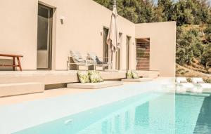 a villa with a swimming pool and a house at Skiathos Symbol Villas in Achladies