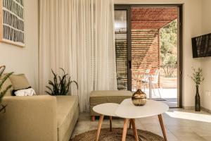a living room with a couch and a table at Skiathos Symbol Villas in Achladies