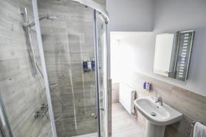 a bathroom with a shower and a sink at Belmont Llandudno in Llandudno